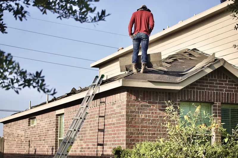 Professional roofer working on a residential roof in Black Canyon Retreat